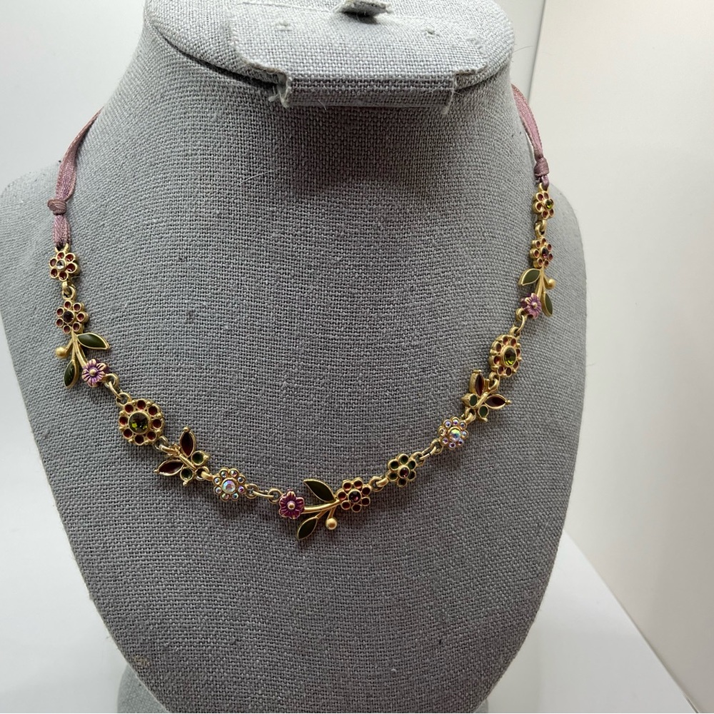 Purple flowers and green butterfly chocker necklace on light purple ribbon.